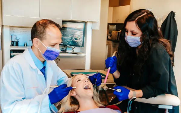 Dr. Gailey and a dental assistant treating a patient at Gateway Family Dentistry